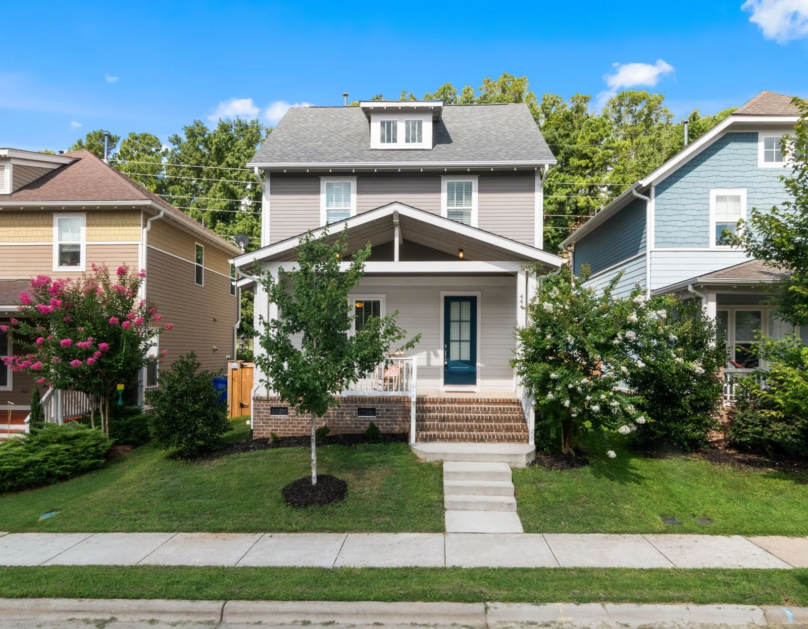 Illustrative house with a front porch and lawn